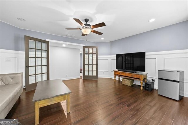 5825 Trailwood Ct, Suwanee, GA 30024 - living room featuring a decorative wall, a ceiling fan, a wainscoted wall, wood finished floors, and french doors