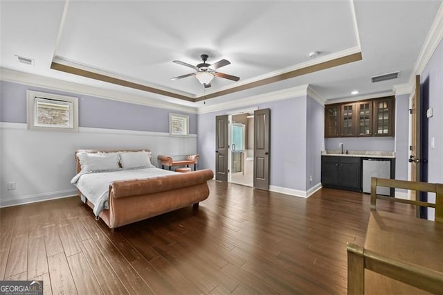 5825 Trailwood Ct, Suwanee, GA 30024 - bedroom with a raised ceiling, wet bar, crown molding, and dark wood-style flooring