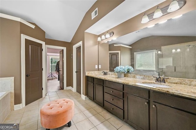 5825 Trailwood Ct, Suwanee, GA 30024 - bathroom featuring vaulted ceiling, double vanity, tile patterned floors, tiled shower, and a relaxing tiled tub