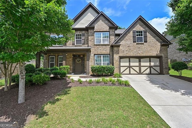 5825 Trailwood Ct, Suwanee, GA 30024 - craftsman house featuring an attached garage, driveway, a front yard, and brick siding