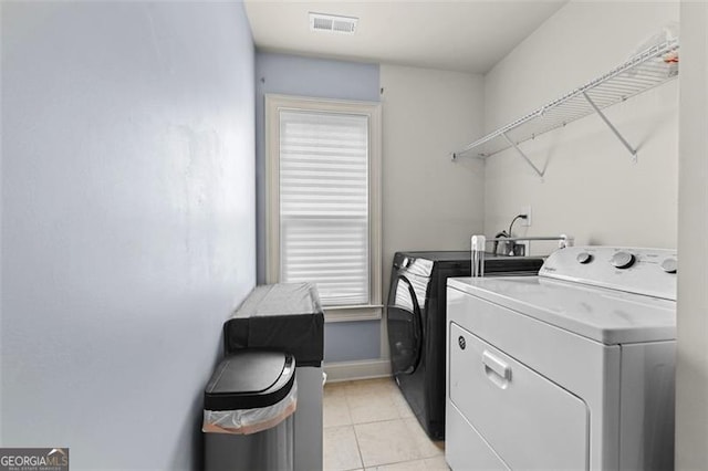 5825 Trailwood Ct, Suwanee, GA 30024 - washroom with separate washer and dryer and light tile patterned floors