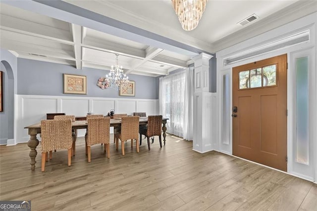 5825 Trailwood Ct, Suwanee, GA 30024 - dining room featuring a chandelier, a decorative wall, beam ceiling, coffered ceiling, and light wood finished floors