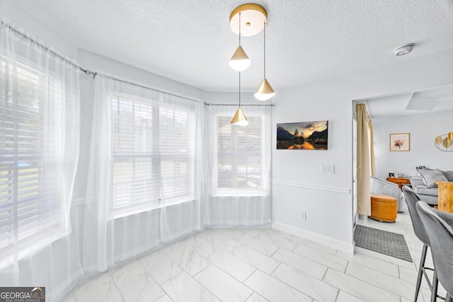 513 Cascade Ct, Hinesville, GA 31313 - unfurnished dining area featuring light marble finish floors and a textured ceiling