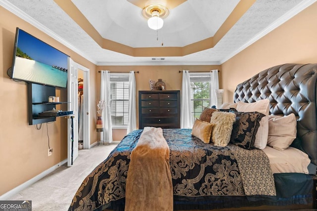 3229 Dunlin Lake Rd, Lawrenceville, GA 30044 - bedroom featuring carpet floors, a raised ceiling, ceiling fan, ornamental molding, and a walk in closet