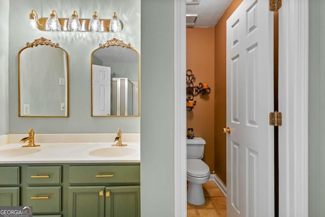 3229 Dunlin Lake Rd, Lawrenceville, GA 30044 - full bathroom with double vanity, tile patterned flooring, a textured ceiling, and a shower with door