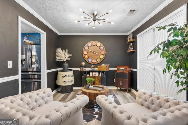 3229 Dunlin Lake Rd, Lawrenceville, GA 30044 - living room featuring a textured ceiling, wood finished floors, a chandelier, and crown molding