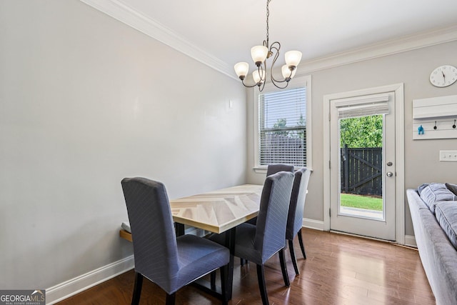 8215 Harlond Way, Suwanee, GA 30024 - dining room featuring crown molding, a chandelier, and wood finished floors