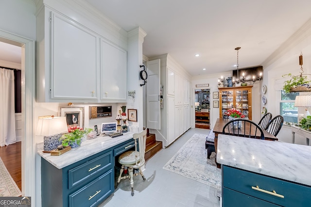 6180 Old Jefferson Rd, Athens, GA 30607 - kitchen with blue cabinetry, built in desk, white cabinetry, a chandelier, and recessed lighting