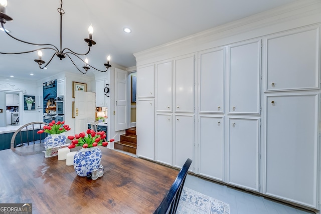 6180 Old Jefferson Rd, Athens, GA 30607 - dining area with stairs, a chandelier, wood finished floors, crown molding, and recessed lighting