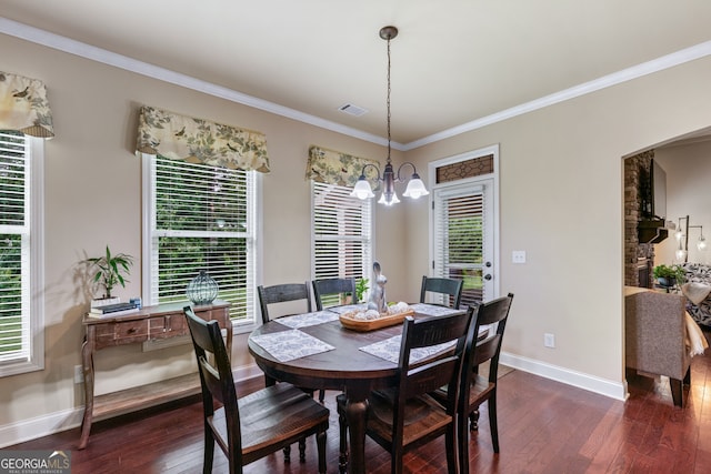 1626 Waterchase Dr, Dacula, GA 30019 - dining area with dark wood finished floors, a chandelier, healthy amount of natural light, and ornamental molding