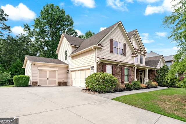 1626 Waterchase Dr, Dacula, GA 30019 - view of home's exterior featuring stone siding, concrete driveway, a shingled roof, an attached garage, and a yard