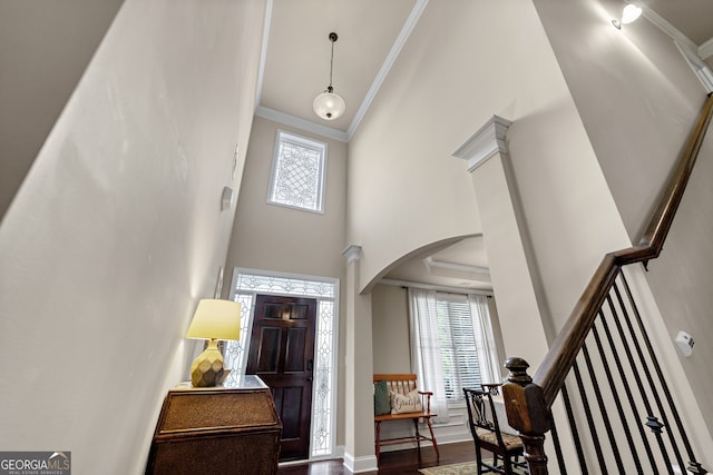 1626 Waterchase Dr, Dacula, GA 30019 - foyer with ornamental molding, arched walkways, a towering ceiling, plenty of natural light, and wood finished floors