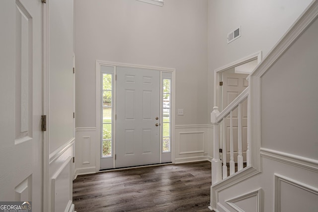 4959 Abbotts Glen Trl NW, Acworth, GA 30101 - entryway featuring a decorative wall, dark wood-type flooring, a wainscoted wall, and a towering ceiling
