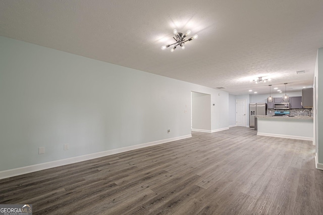4959 Abbotts Glen Trl NW, Acworth, GA 30101 - unfurnished living room with a textured ceiling and dark wood-style floors