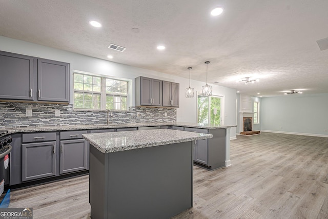 4959 Abbotts Glen Trl NW, Acworth, GA 30101 - kitchen with gray cabinets, a peninsula, decorative backsplash, a center island, and a textured ceiling