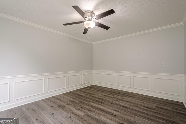 4959 Abbotts Glen Trl NW, Acworth, GA 30101 - spare room featuring dark wood finished floors, ceiling fan, ornamental molding, and a wainscoted wall