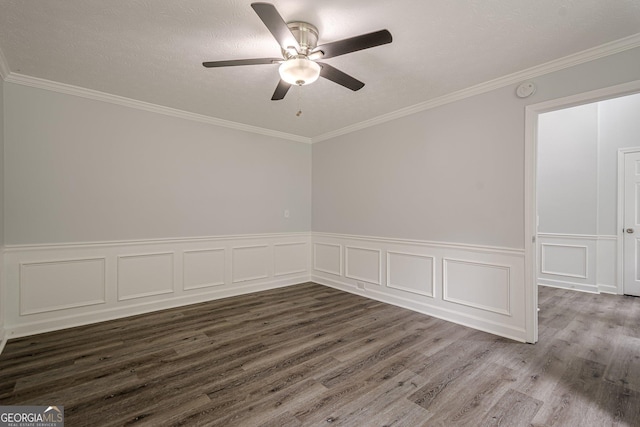 4959 Abbotts Glen Trl NW, Acworth, GA 30101 - spare room with dark wood-type flooring, a ceiling fan, a wainscoted wall, crown molding, and a smoke detector
