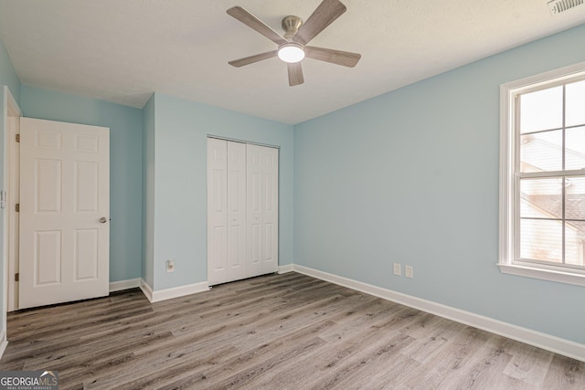 4959 Abbotts Glen Trl NW, Acworth, GA 30101 - unfurnished bedroom featuring wood finished floors, a closet, and ceiling fan