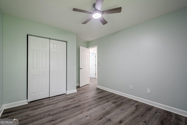 4959 Abbotts Glen Trl NW, Acworth, GA 30101 - unfurnished bedroom with dark wood finished floors, a closet, and a ceiling fan