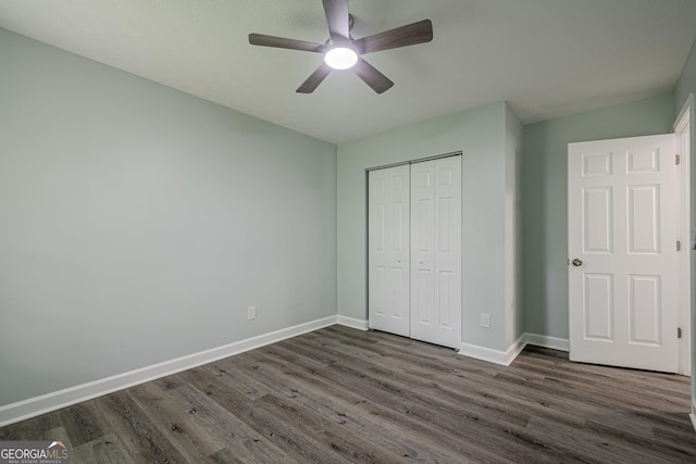 4959 Abbotts Glen Trl NW, Acworth, GA 30101 - unfurnished bedroom featuring dark wood finished floors, a closet, and ceiling fan