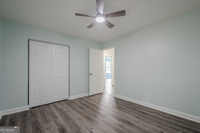 4959 Abbotts Glen Trl NW, Acworth, GA 30101 - unfurnished bedroom with wood finished floors, a closet, and ceiling fan