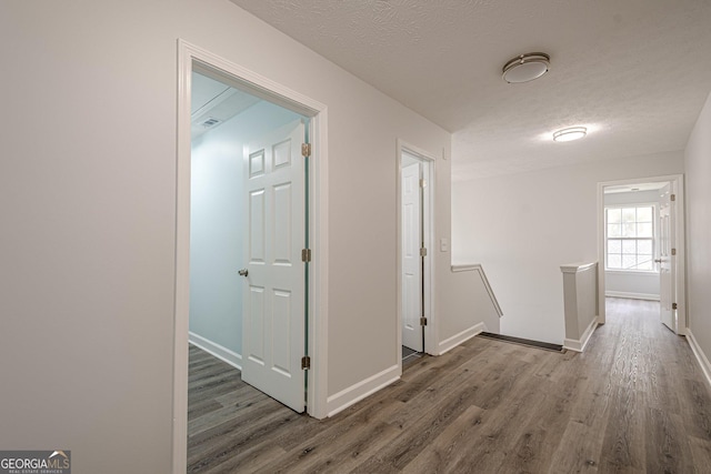 4959 Abbotts Glen Trl NW, Acworth, GA 30101 - hallway with wood finished floors, an upstairs landing, and a textured ceiling
