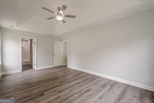 4959 Abbotts Glen Trl NW, Acworth, GA 30101 - unfurnished bedroom featuring a raised ceiling, wood finished floors, ensuite bathroom, and ceiling fan