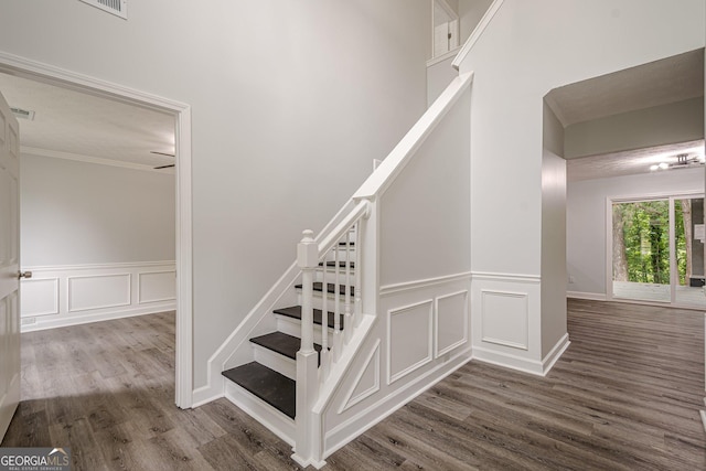 4959 Abbotts Glen Trl NW, Acworth, GA 30101 - stairway featuring wood finished floors, a decorative wall, crown molding, and a wainscoted wall