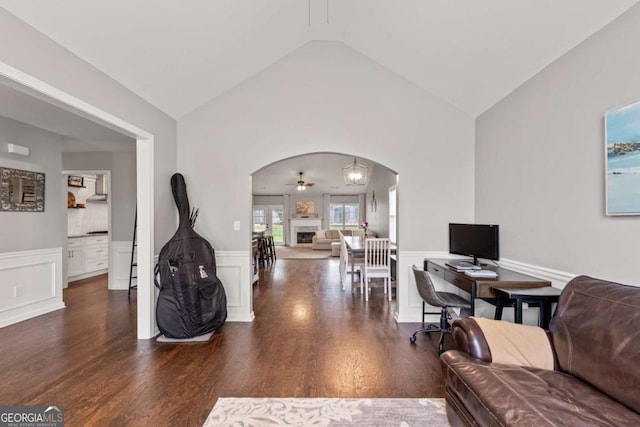 192 Sandhurst Ct, Suwanee, GA 30024 - living area featuring arched walkways, wood finished floors, wainscoting, vaulted ceiling, and a ceiling fan
