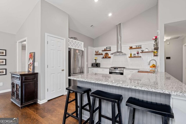 192 Sandhurst Ct, Suwanee, GA 30024 - kitchen with open shelves, stainless steel appliances, a peninsula, dark wood-type flooring, and light stone countertops