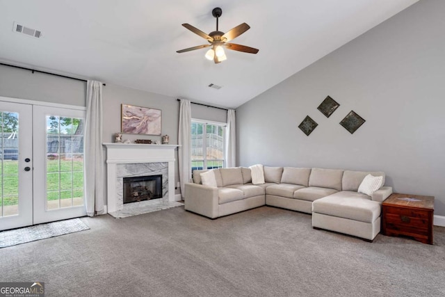 192 Sandhurst Ct, Suwanee, GA 30024 - living area featuring carpet floors, ceiling fan, french doors, lofted ceiling, and a premium fireplace