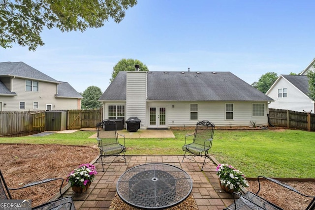 192 Sandhurst Ct, Suwanee, GA 30024 - rear view of property featuring french doors, an outdoor fire pit, a patio, a chimney, and a fenced backyard