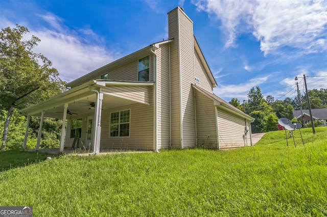 3376 Trotters Ridge Trl, Gray, GA 31032 - view of property exterior with ceiling fan, a chimney, and a lawn