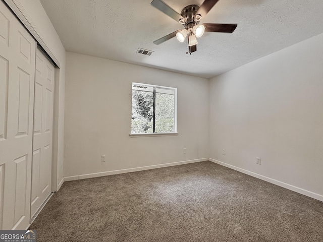 10173 Brass Ring Rd, Jonesboro, GA 30238 - unfurnished bedroom featuring a textured ceiling, carpet, a closet, and a ceiling fan