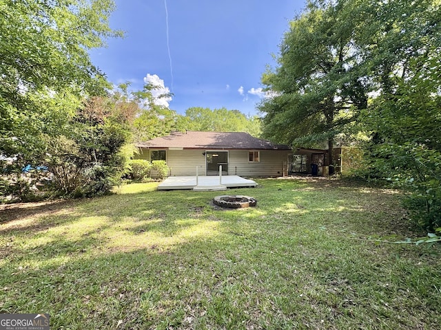 10173 Brass Ring Rd, Jonesboro, GA 30238 - rear view of house with a fire pit, a deck, and a yard