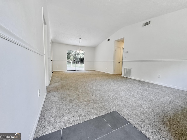 10173 Brass Ring Rd, Jonesboro, GA 30238 - carpeted empty room with a chandelier and vaulted ceiling