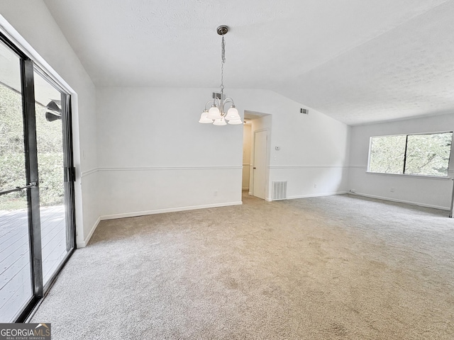 10173 Brass Ring Rd, Jonesboro, GA 30238 - carpeted empty room featuring a chandelier, lofted ceiling, and a textured ceiling