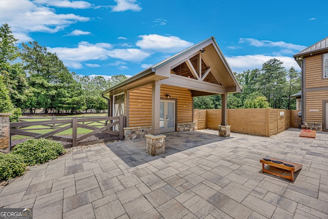 6590 Lights Ferry Rd, Flowery Branch, GA 30542 - fenced backyard featuring french doors and a patio