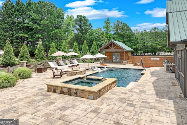 6590 Lights Ferry Rd, Flowery Branch, GA 30542 - view of swimming pool with a storage structure, a patio, an outbuilding, a pool with connected hot tub, and view of scattered trees