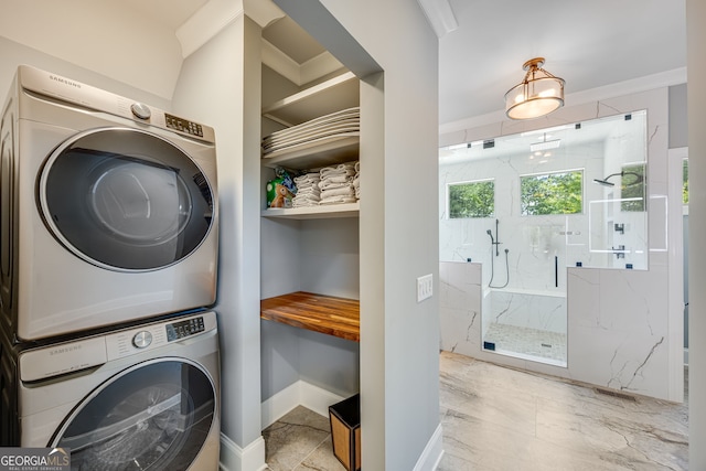 6590 Lights Ferry Rd, Flowery Branch, GA 30542 - laundry area with stacked washing machine and dryer and crown molding