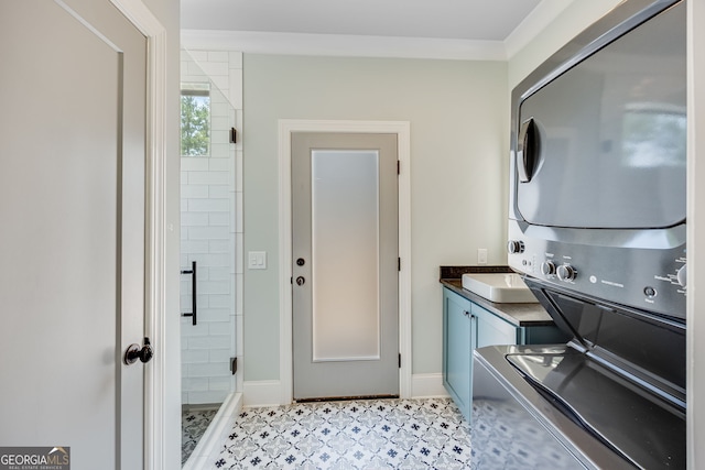 6590 Lights Ferry Rd, Flowery Branch, GA 30542 - washroom with stacked washing machine and dryer and cabinet space