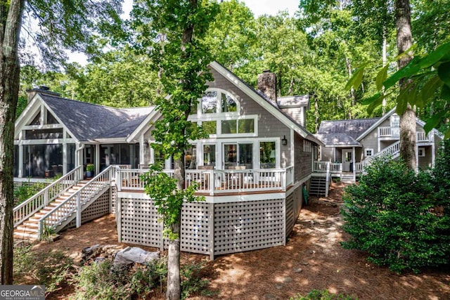 1320 Dogwood Drive 1320Dogwood Drive, Greensboro, GA 30642 - rear view of house featuring a sunroom, a chimney, stairs, and a deck