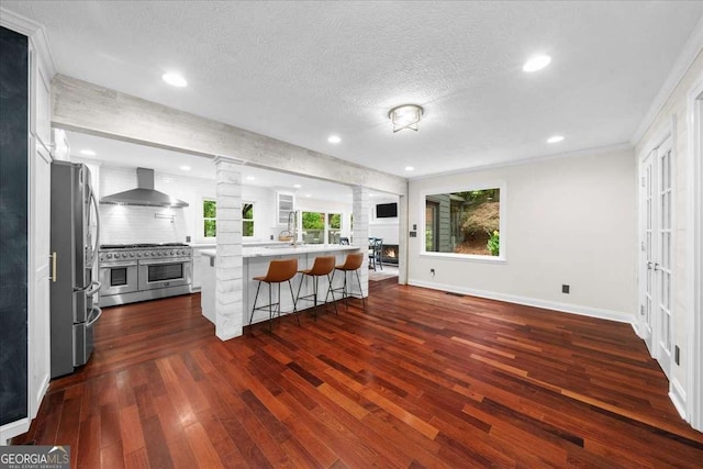 4735 Log Cabin Rd, Gainesville, GA 30504 - living area with ornate columns, dark wood-style flooring, a textured ceiling, recessed lighting, and crown molding