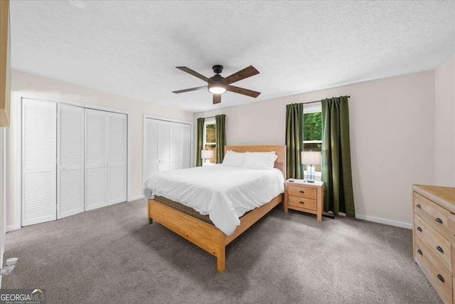 4735 Log Cabin Rd, Gainesville, GA 30504 - carpeted bedroom featuring two closets, a textured ceiling, and a ceiling fan