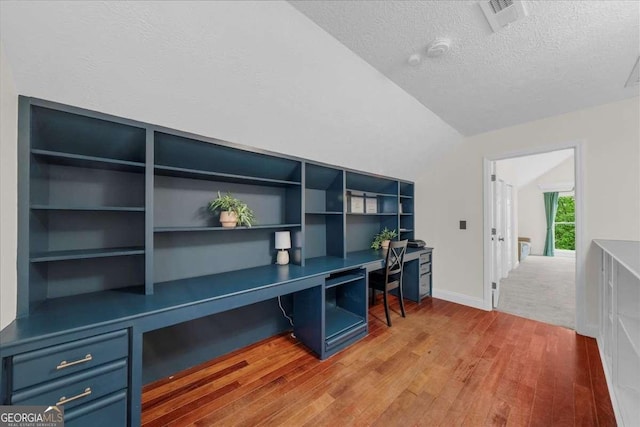 4735 Log Cabin Rd, Gainesville, GA 30504 - office area featuring built in desk, light wood-type flooring, a textured ceiling, and lofted ceiling