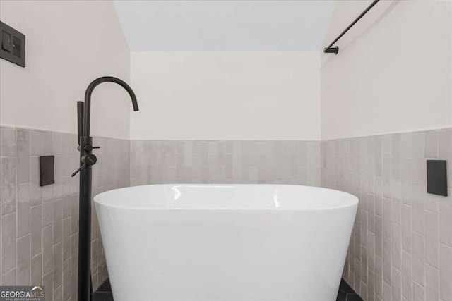 4735 Log Cabin Rd, Gainesville, GA 30504 - full bathroom featuring tile walls, wainscoting, and a soaking tub