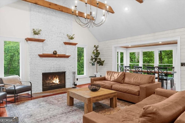 4735 Log Cabin Rd, Gainesville, GA 30504 - living area featuring high vaulted ceiling, healthy amount of natural light, a fireplace, wood finished floors, and a chandelier
