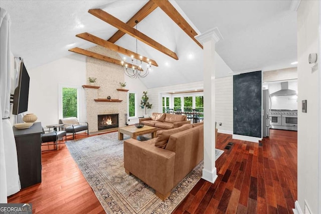 4735 Log Cabin Rd, Gainesville, GA 30504 - living area with beam ceiling, a fireplace, wood finished floors, healthy amount of natural light, and high vaulted ceiling