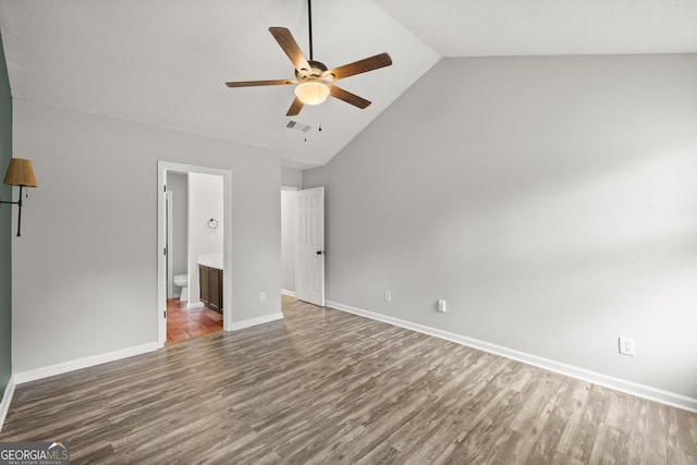 615 Coan Dr, Locust Grove, GA 30248 - unfurnished bedroom with wood finished floors, high vaulted ceiling, ensuite bath, and a ceiling fan
