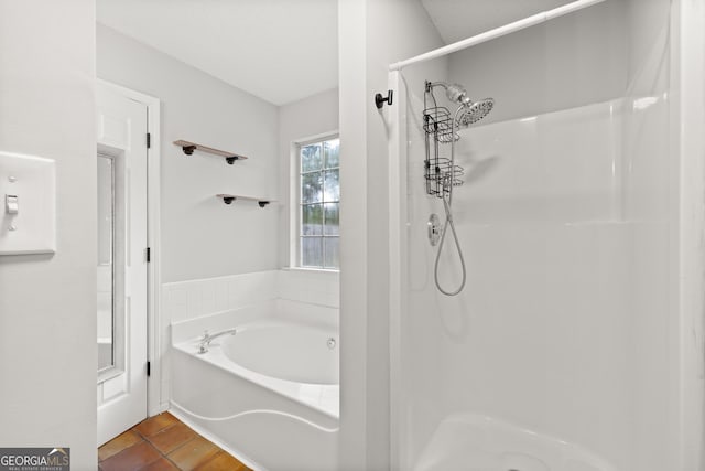 615 Coan Dr, Locust Grove, GA 30248 - bathroom featuring a shower, a garden tub, and tile patterned flooring